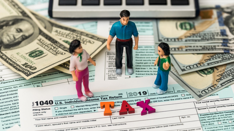 people figurines and tax documents