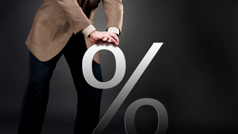 man pushing down percentage symbol