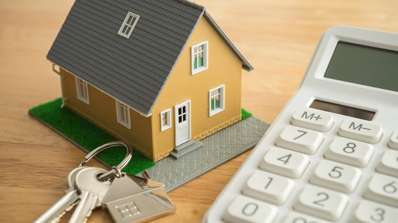 Model home with keys and a calculator