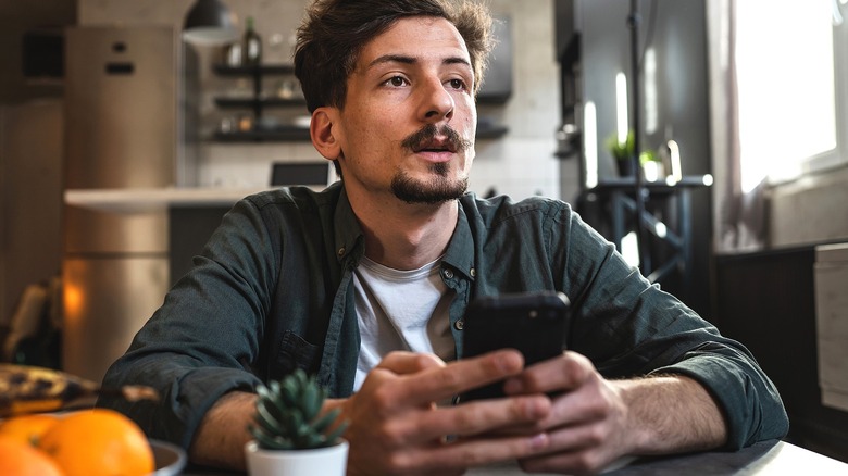 Person on smartphone in disbelief