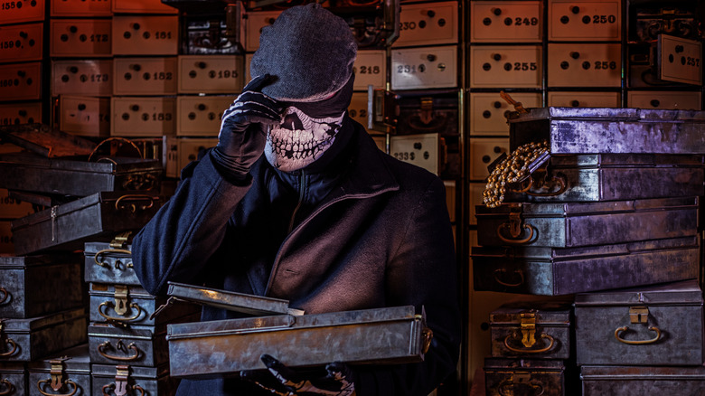 A masked bank robber inside a vault with open safety deposit boxes