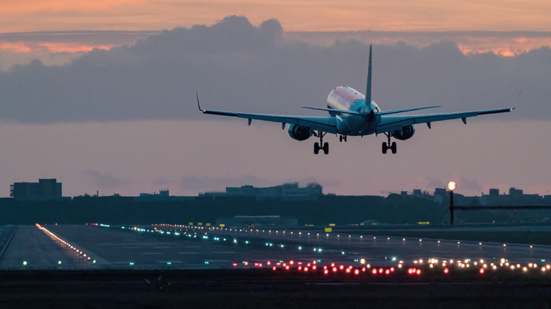 airplane landing at sunrise