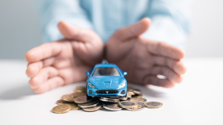 car figurine on a stack of coins