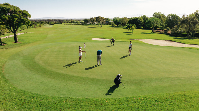 a foursome on the green