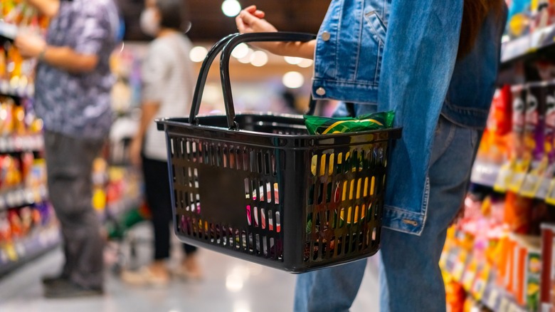 woman holding grocery basket