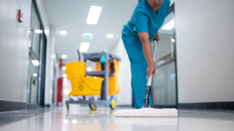 hospital employee mopping the floor