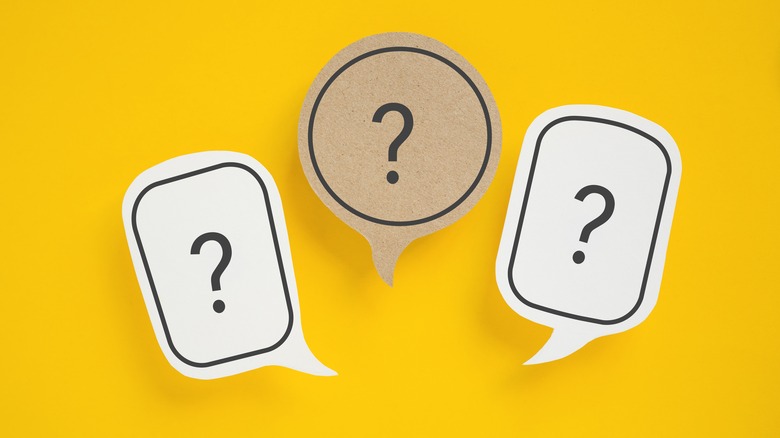 A yellow background with three thought bubbles containing question marks.