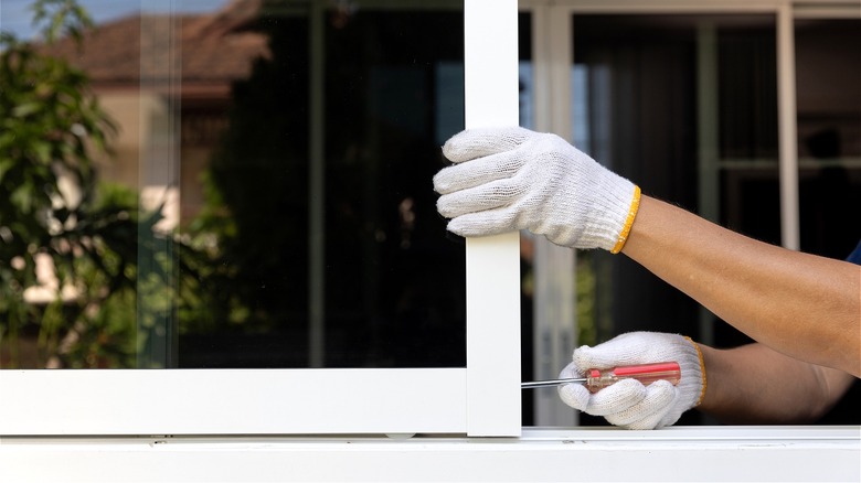 Person fixing sliding home window