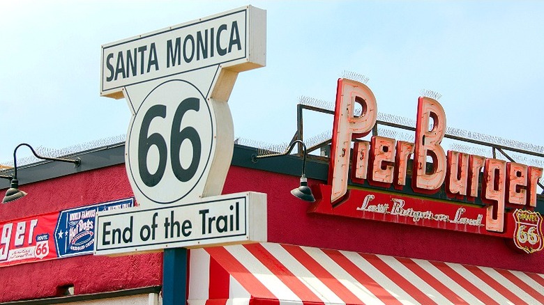 Santa Monica Route 66 'End of the Trail' sign outside of Pier Burger