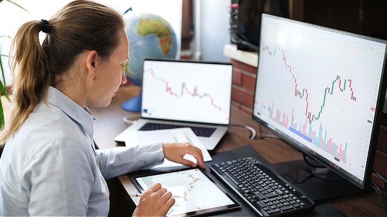 Woman looking at stock market exchange data on computer