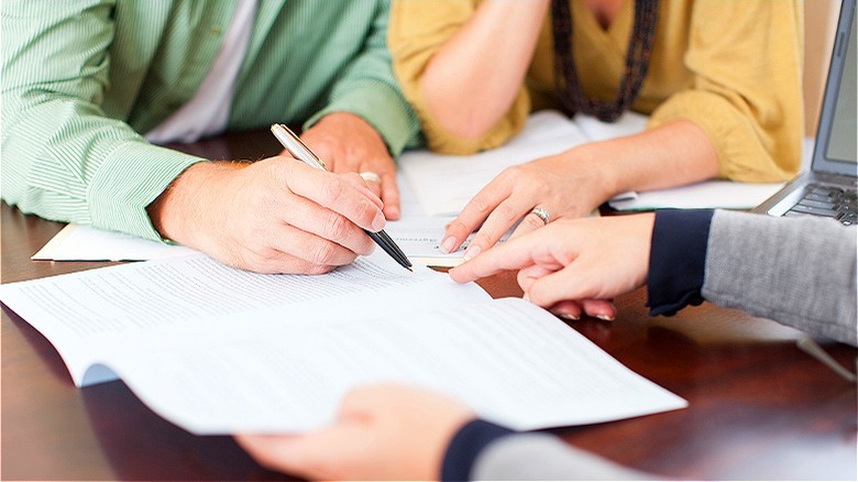 Couple signing loan agreement