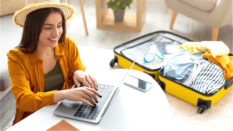 Person with suitcase planning vacation