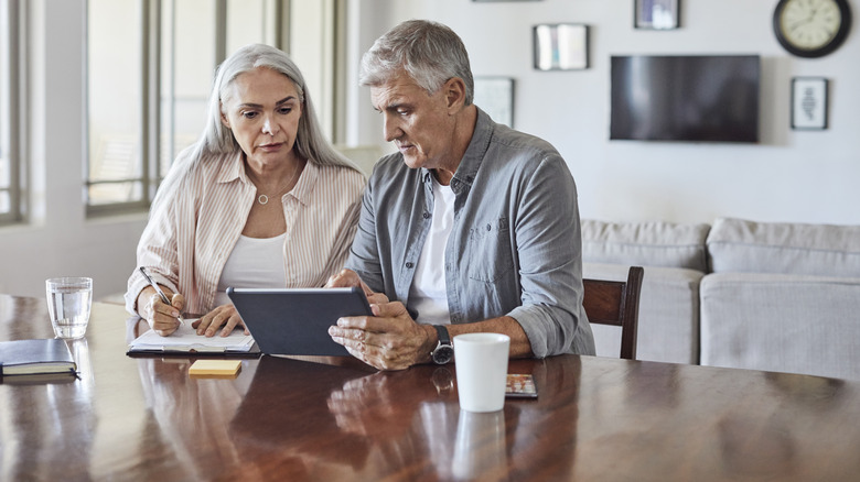 Mature man and woman planning home finances