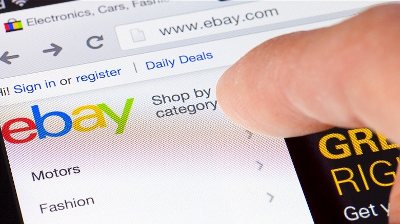 Person pointing at eBay webpage