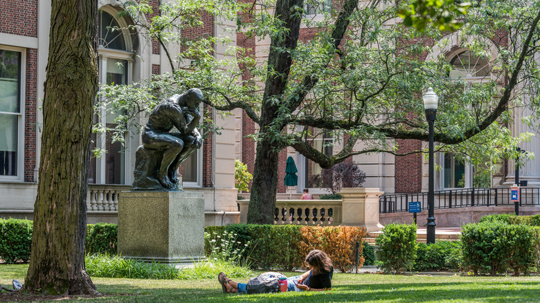 Student sitting on campus lawn