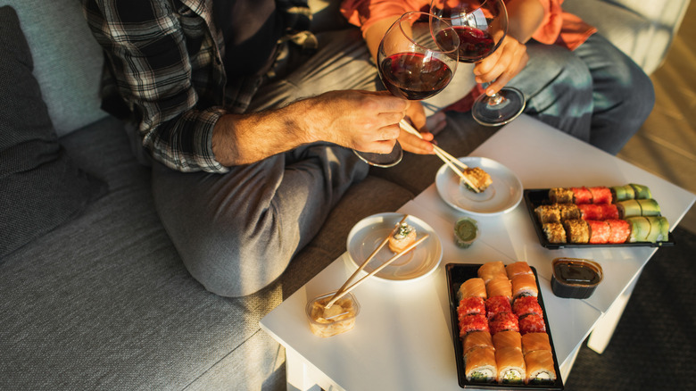 Couple eating takeout food delivery