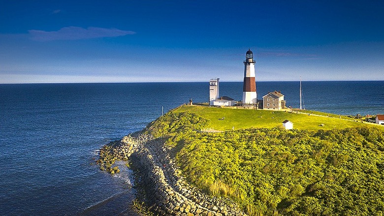 The old Montauk Point lighthouse against the blue ocean.