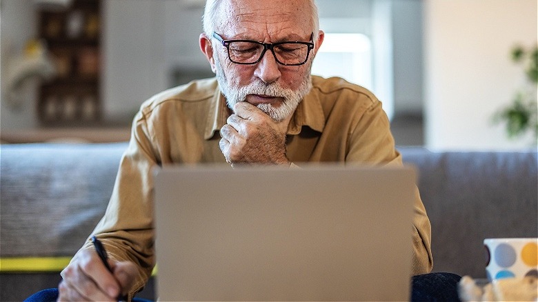 Retiree reading from laptop