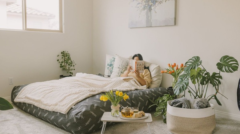 A woman reading in a comfy bed