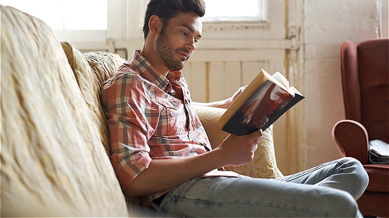 Person reading book at home