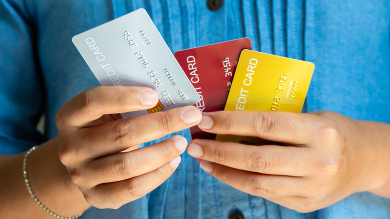 Woman holding three credit cards