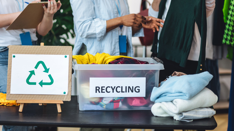 A donation pile with a bin marked recycling.