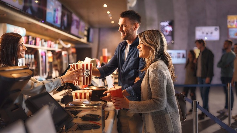 Couple buying concessions at movie theater