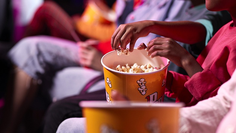 People eating popcorn at movie theater