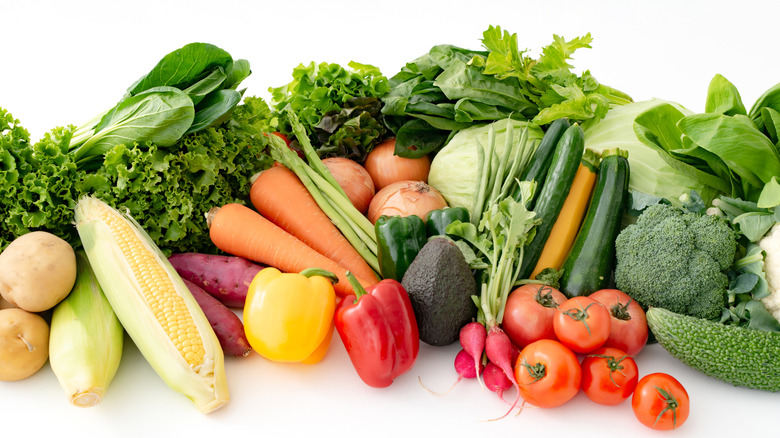 A vibrant spread of fresh produce against a white background.