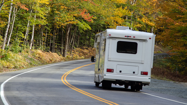 motorhome driving among fall leaves changing color