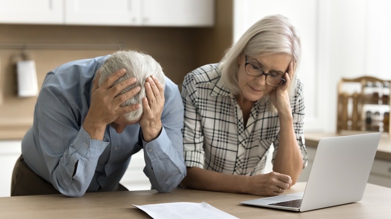 older couple looking depressed