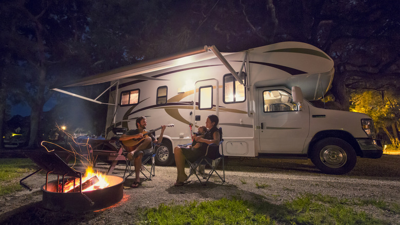 couple with child camping with a motorhome