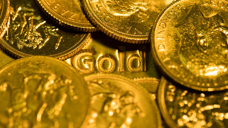 gold coins surrounding the word gold on bar beneath