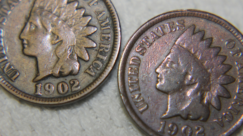 A pair of 1902 Indian Head pennies.