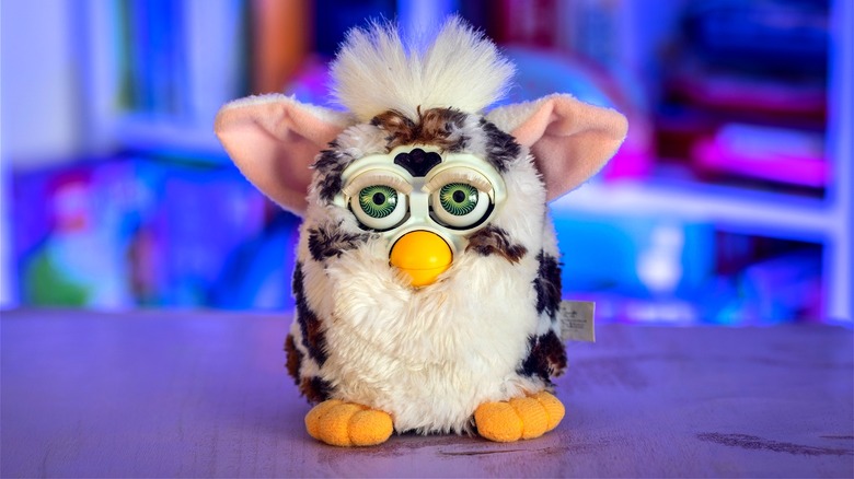 Black-and-white Furby on purple table