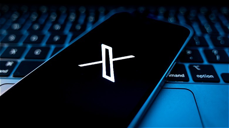 "X" app phone on laptop