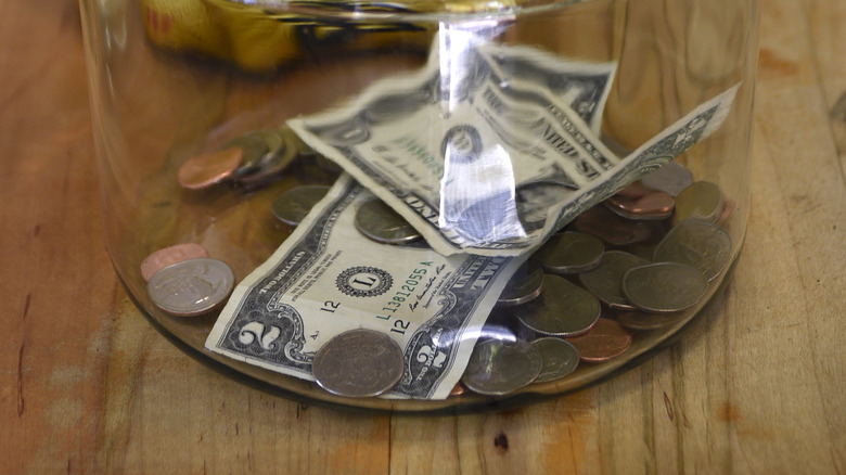 tip jar containing $2 bill
