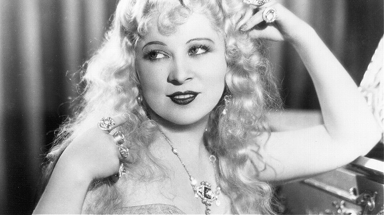 Mae West tousles her hair