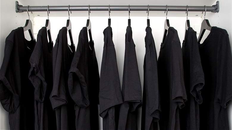 Black T-shirts hanging in closet