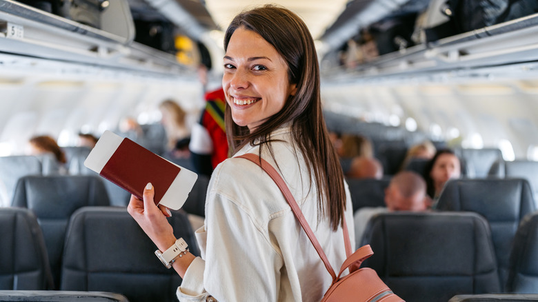 A young woman boarding an airplane