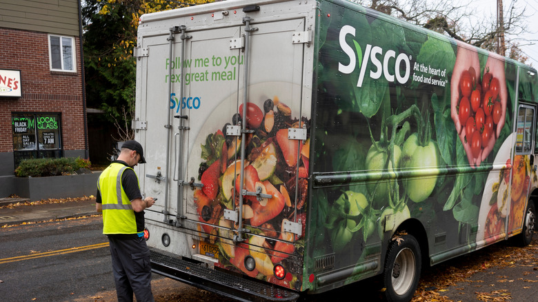 A Sysco delivery truck and driver