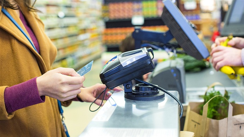 Swiping card at grocery store