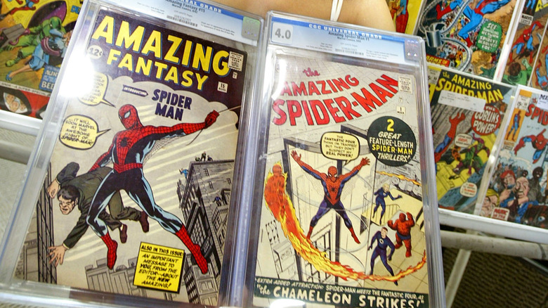 Two enclosed Spider-Man books are displayed in front of other comics