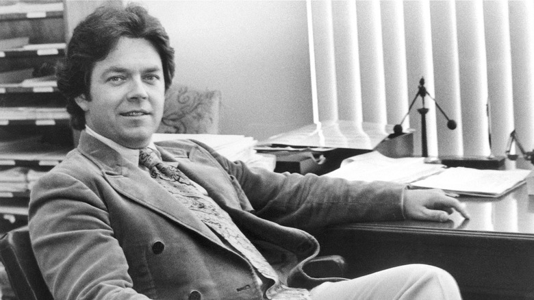 Arthur Laffer at desk smiling as he looks into camera