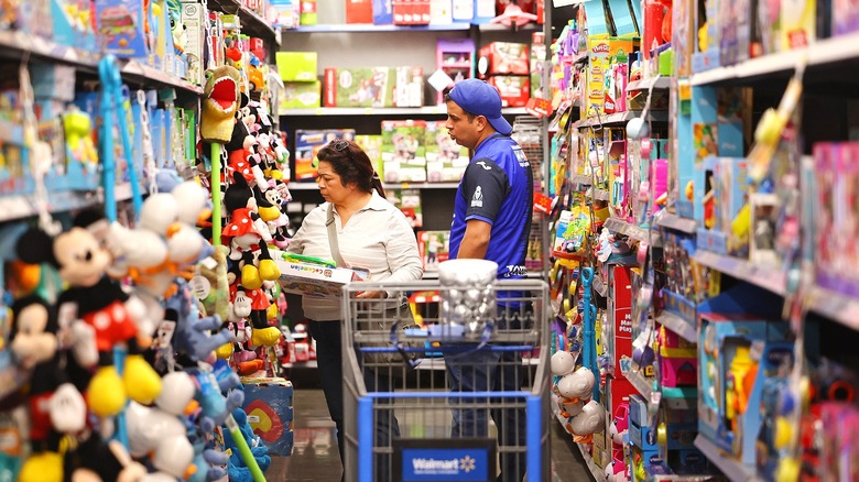 Two people shop the toy aisle at Walmart