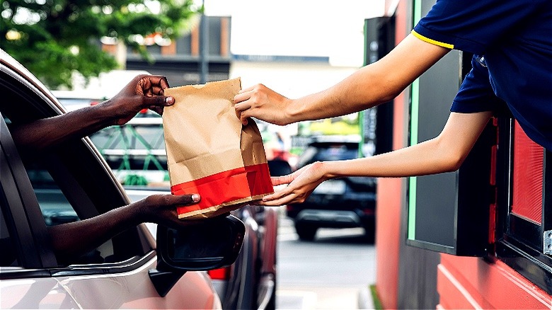 Person getting drive-thru window order