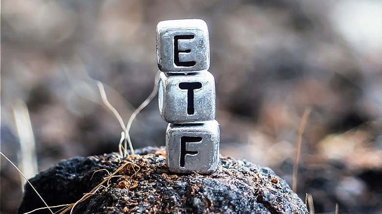 "ETF" squares stacked on rock