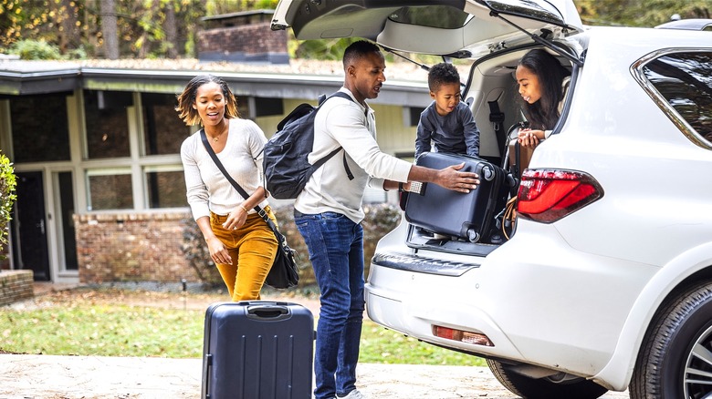 Family loading car for vacation