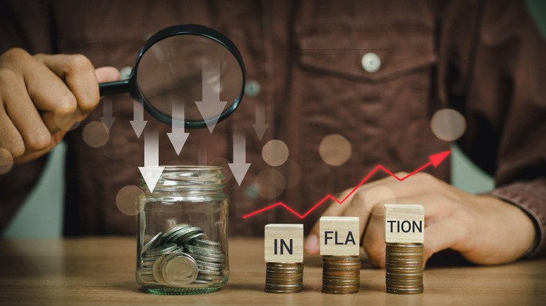 composite image of blocks spelling inflation and jar of coins coins