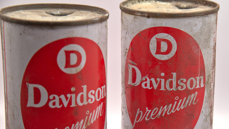 Two vintage Davidson premium beer cans, with their steel flat tops visible.